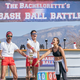 Franco Lacosta, Wells Adams, and Katie Thurston standing under a sign that says "The Bachelorette's Bash Ball Battle"